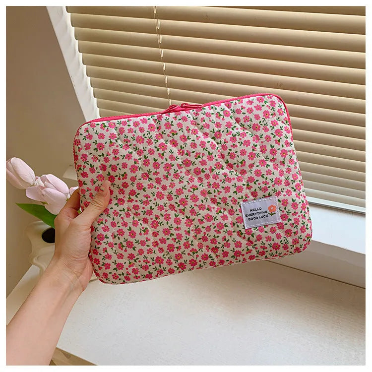 Flower print cloth laptop bag in green floral pattern showing three size options for laptop protection