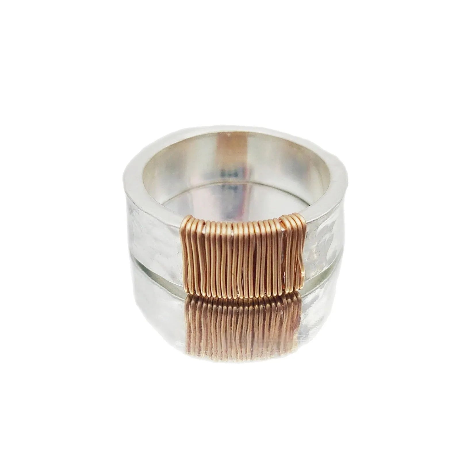 Copper wide face ring with irregular coil design in silver-gold colour.
