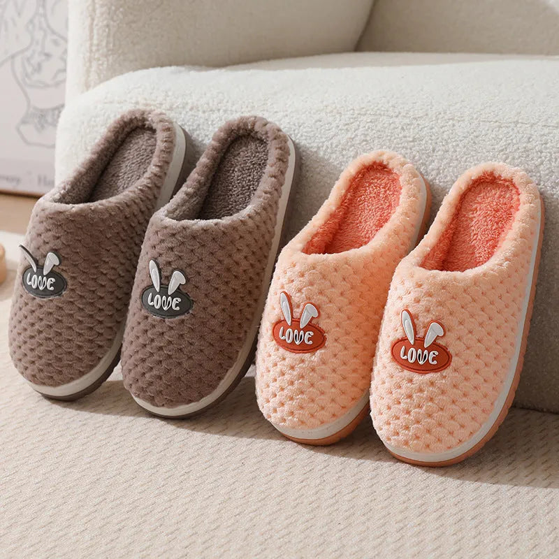 Rabbit plaid design women's house slippers in artificial fur with a flat heel and rubber sole.