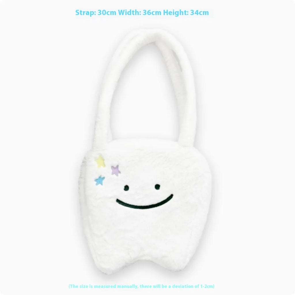 White shoulder tote bag with plush large tooth decorative detail and zip closure