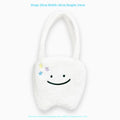 White shoulder tote bag with plush large tooth decorative detail and zip closure