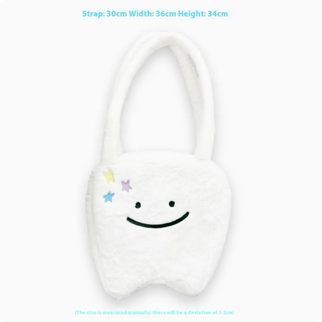 White shoulder tote bag with plush large tooth decorative detail and zip closure
