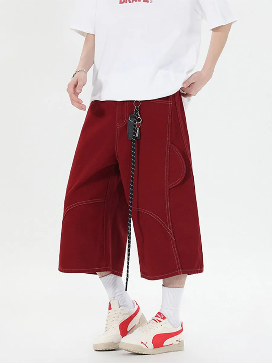 Retro denim multi-pocket workwear shorts in a wide leg cropped style, shown in red and black.