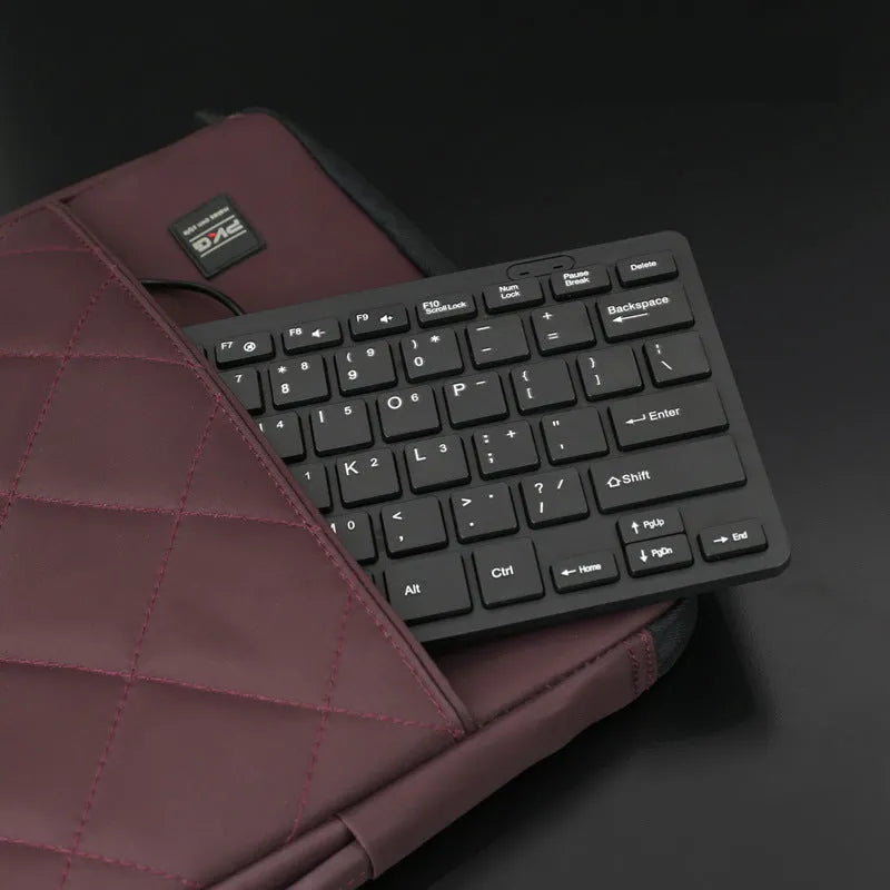 Mini wired USB computer keyboard in black, white, pink, or blue colour options.