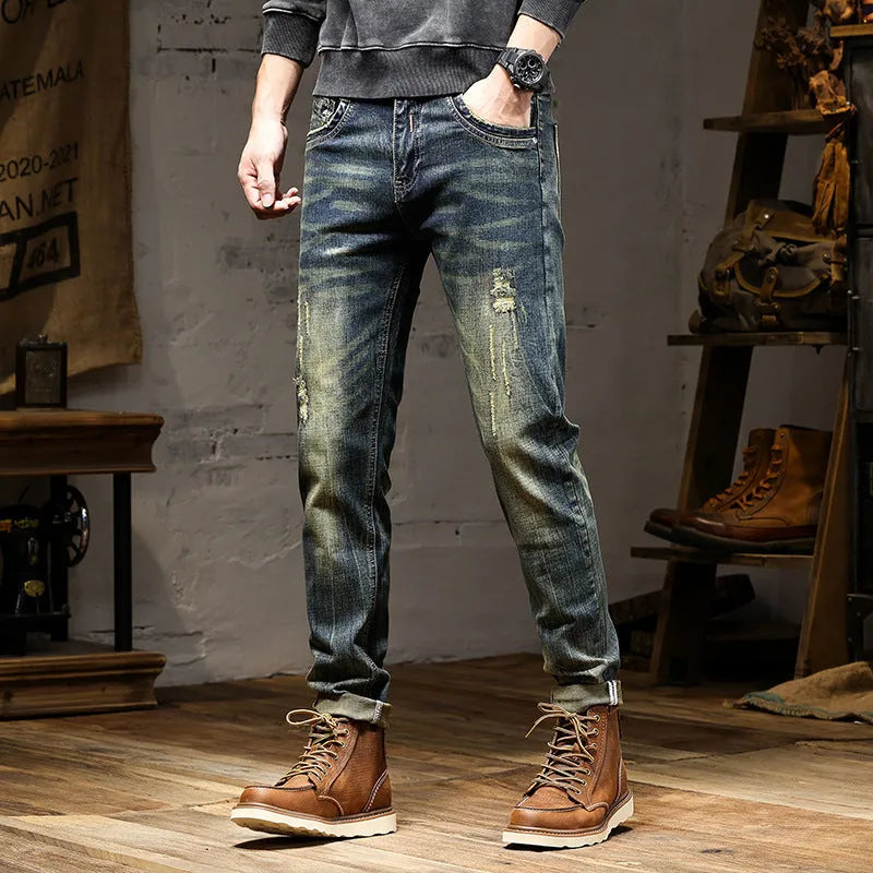 Men's skinny fit retro blue jeans with a zip fly on a plain background