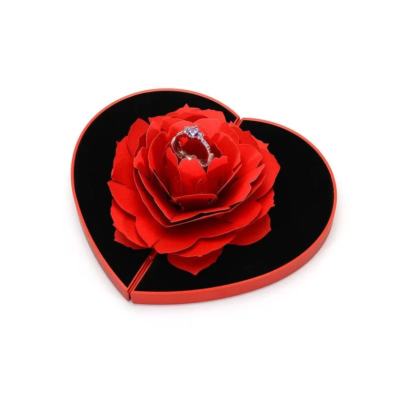 3D Love Box heart-shaped rotating rose flower ring box in red plastic on white background