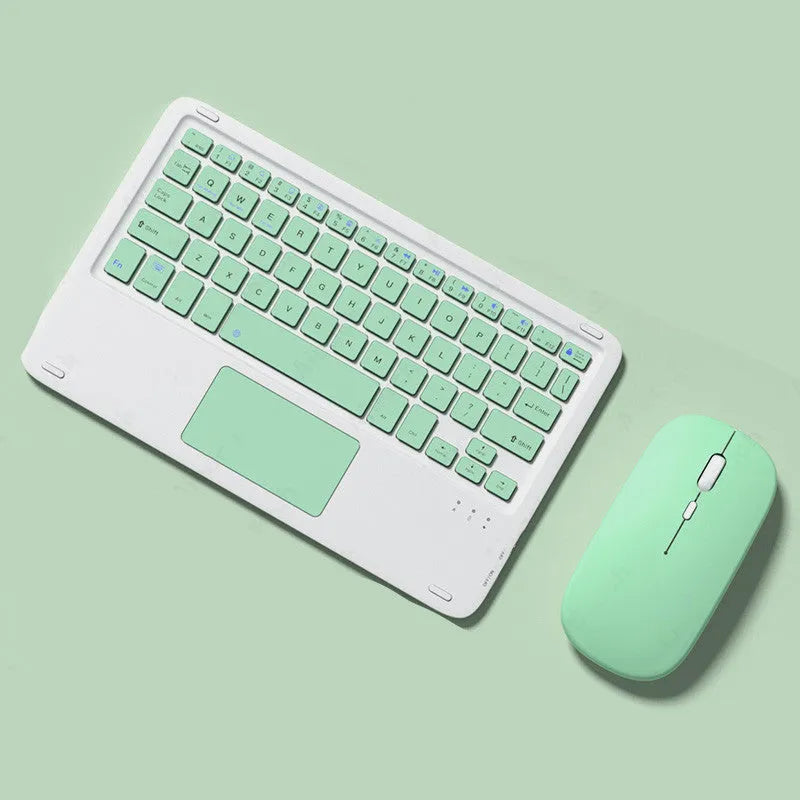 Pink wireless Bluetooth keyboard and mute mouse with USB charging cable on a desk