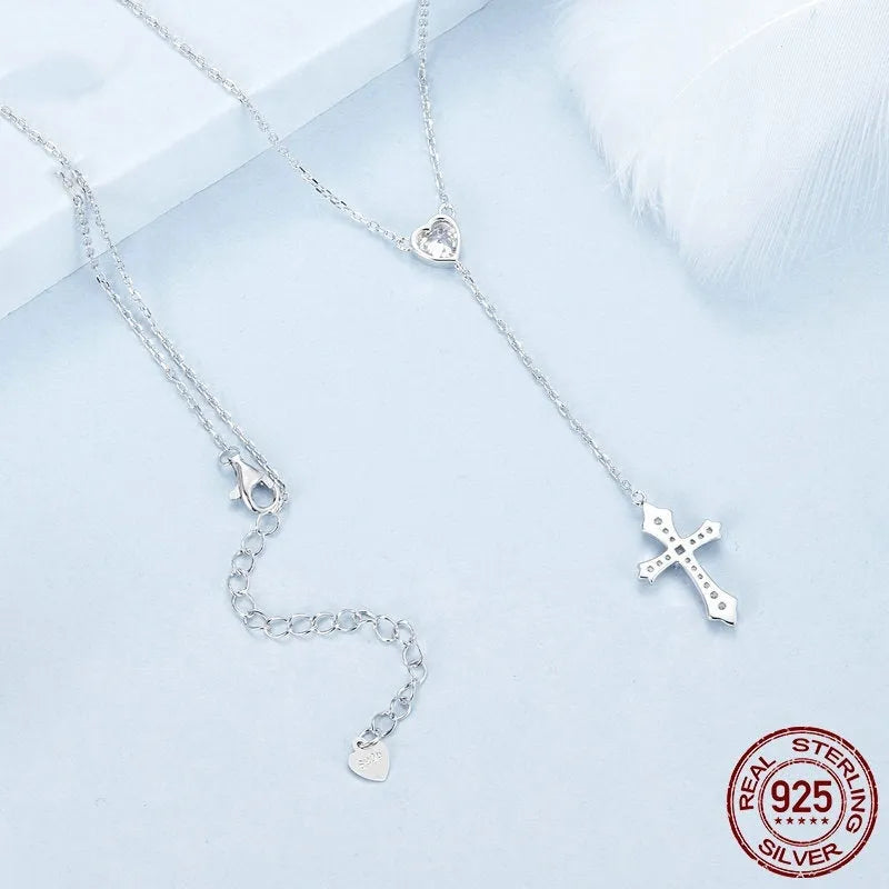 Simple sterling silver V-neck cross pendant on an O-ring chain necklace.