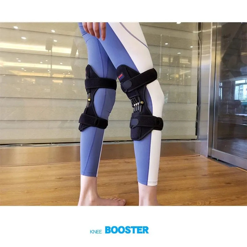 Adjustable black spring knee brace with straps and venting holes for sports support.