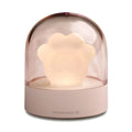 Grey or pink cat paw shaped USB rechargeable night light with music box function on a desk.