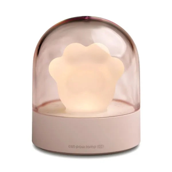 Grey or pink cat paw shaped USB rechargeable night light with music box function on a desk.