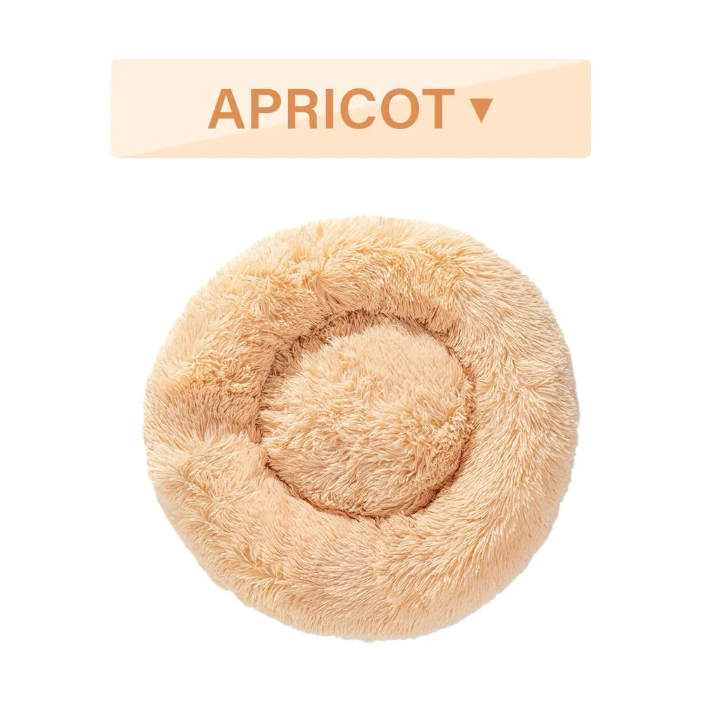 Fluffy donut-shaped pet bed in long plush fabric, shown in a light grey colour.