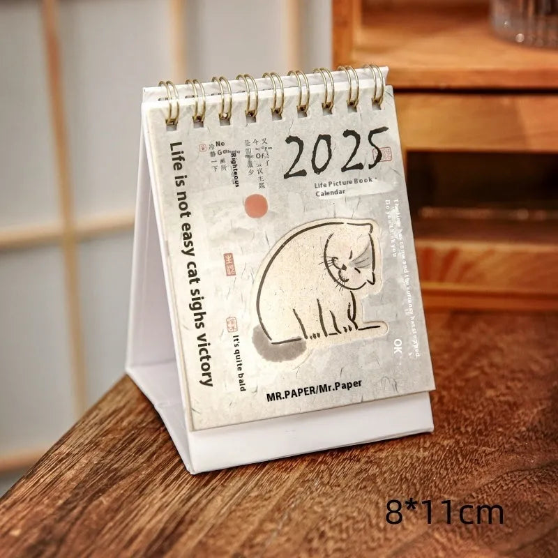 Mini 2025 desk calendar in a simple modern design on a wooden desk