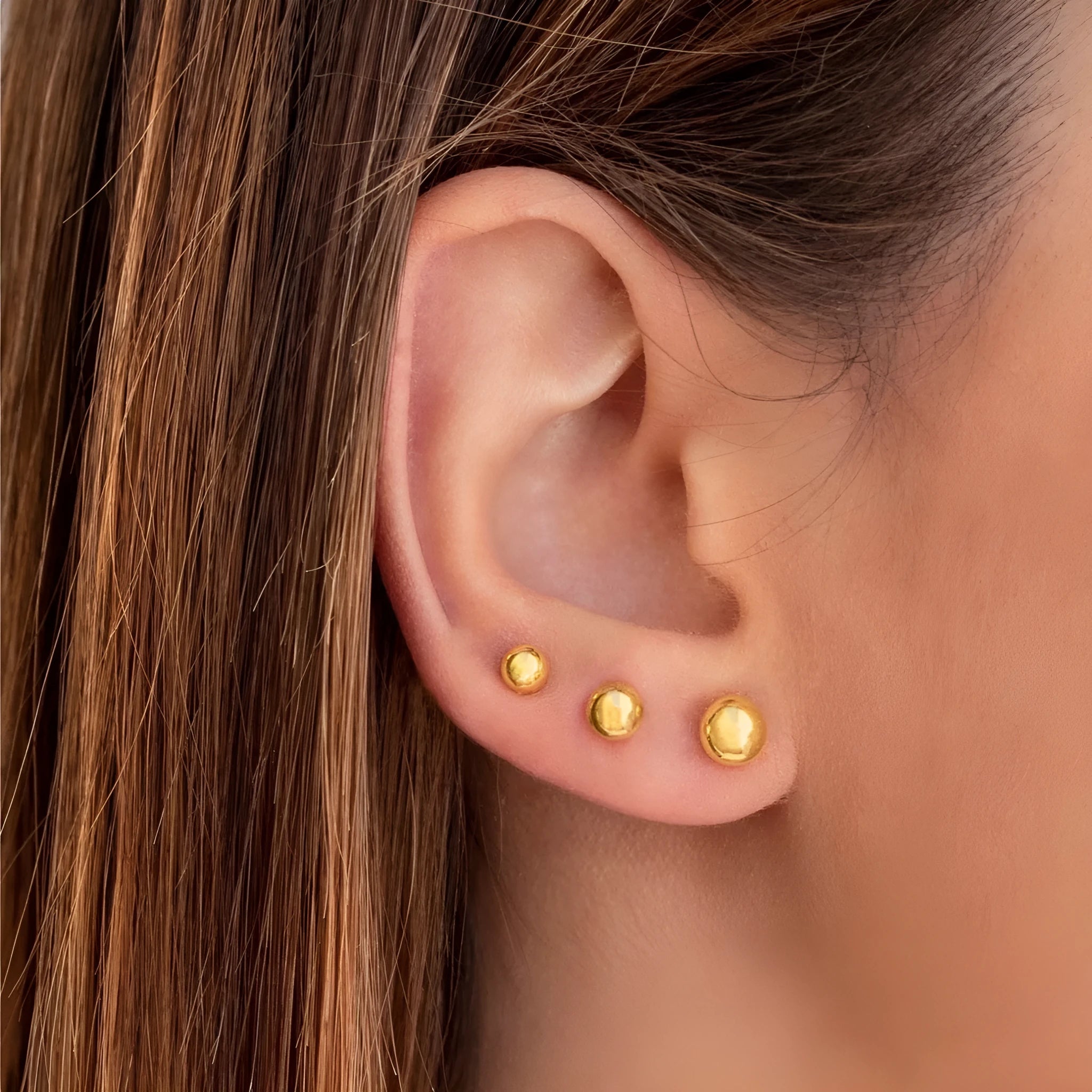 Stainless steel ball stud earrings in gold and silver colours with geometric round design