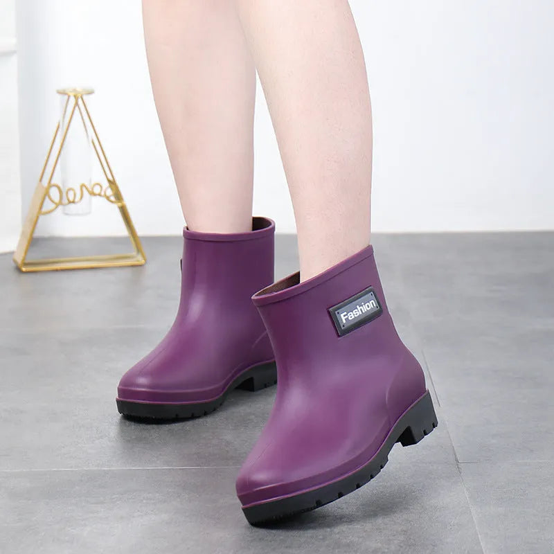 Women's mid-calf PVC rain boot in black, shown with a low heel and optional wool lining.