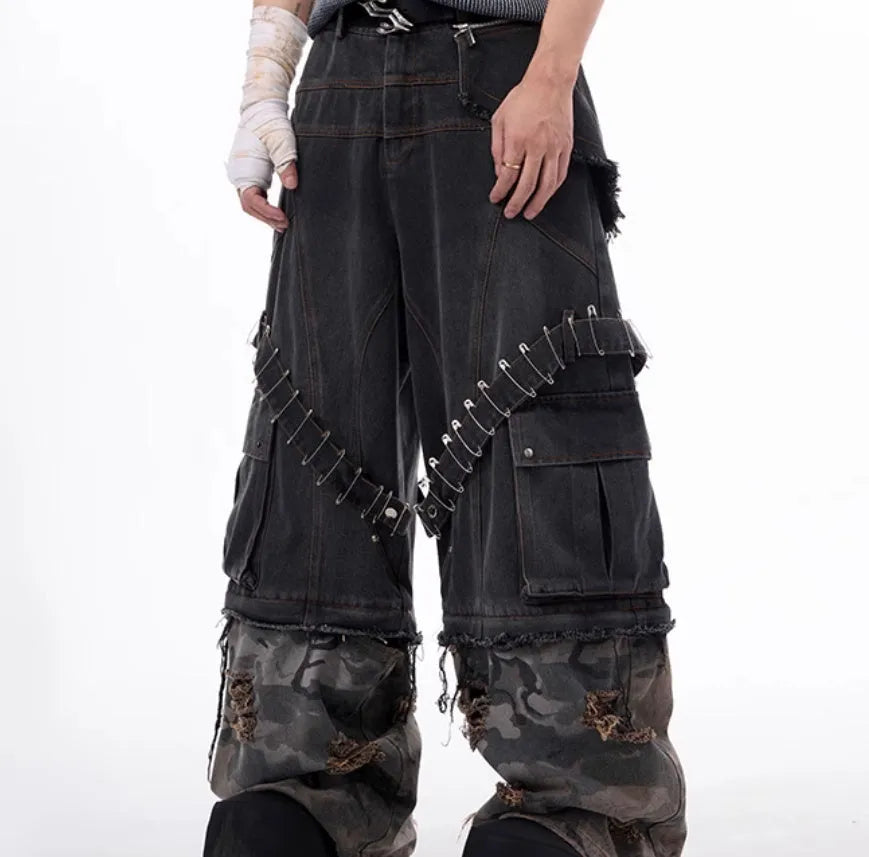 Men's grey camouflage jeans with splicing panel design and decorative pin and ribbon details