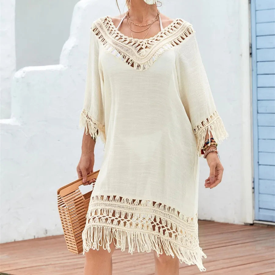 Apricot coloured women's crocheted patchwork dress with half sleeves on a hanger