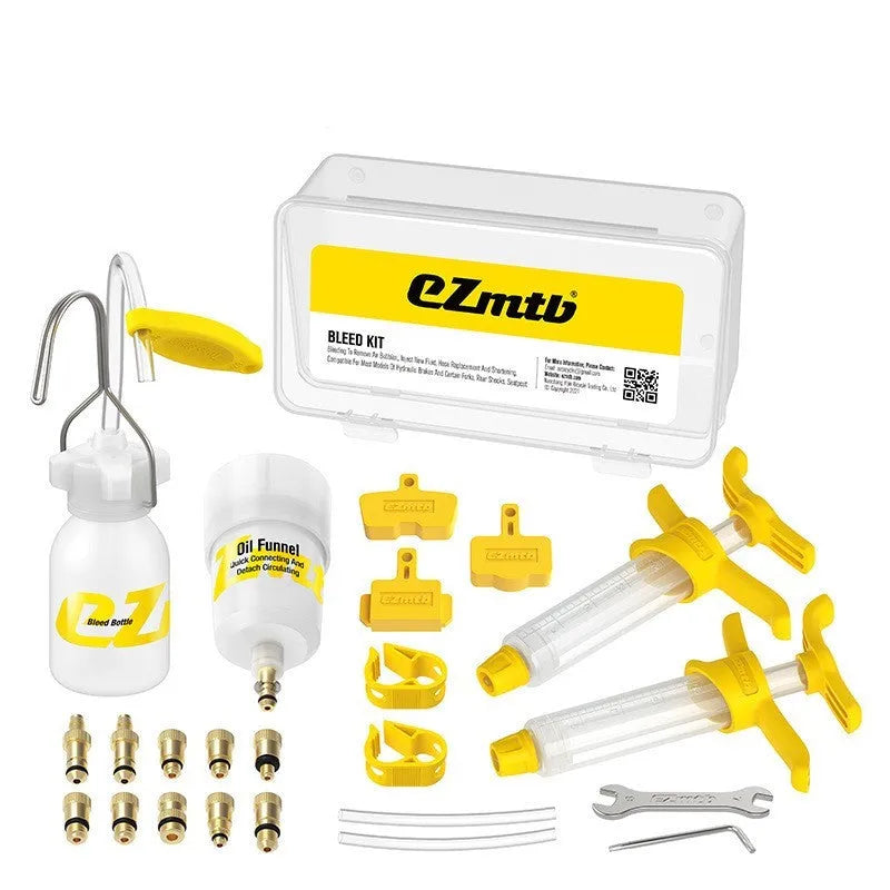 EZmtb bicycle hydraulic brake bleed kit showing syringes, funnels, adapters, and wrenches on a table