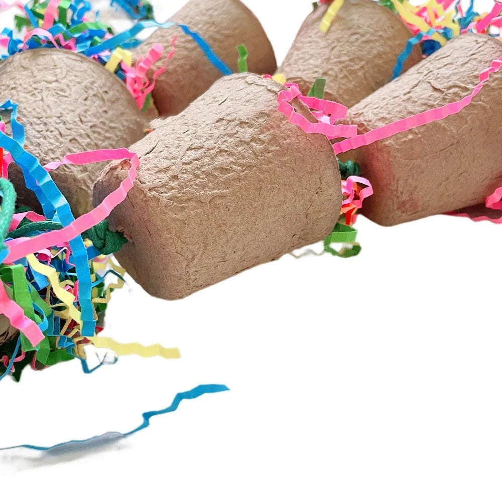 Parrot chew toy with woven palm fibres and a paper cup, hanging 38 cm long in a natural wood colour.
