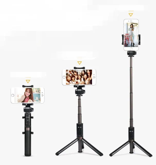 Aluminium Bluetooth selfie stick with tripod base and remote control next to a mobile phone.