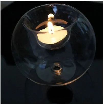 Handmade round transparent glass candle holder showing hollow centre for a candle