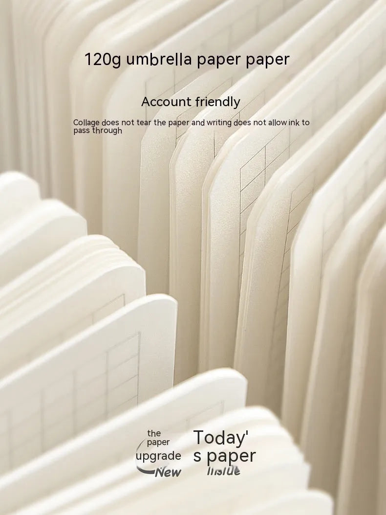Small white square notebook with checkered pages and decorative sticker sheets