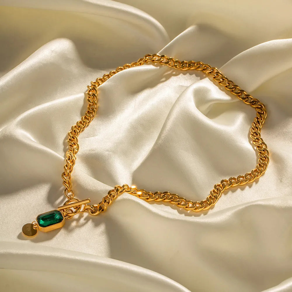 Gold coloured geometric zircon pendant necklace on a Cuban link chain for women.