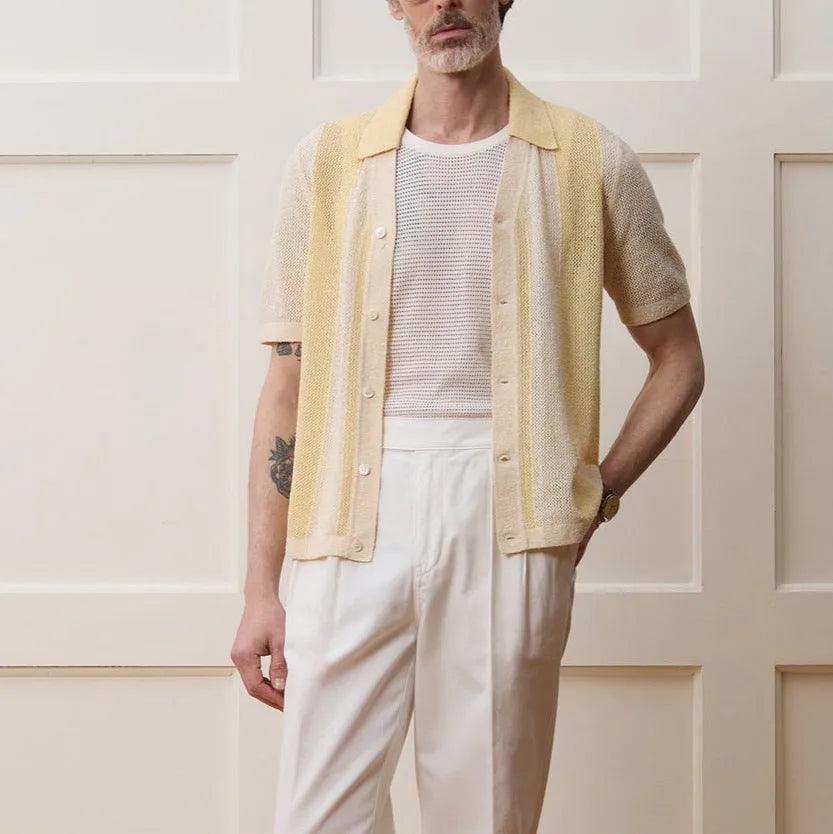 Yellow women's Tencel polo shirt with an asymmetric hemline and hollow-out detail on a short sleeve.