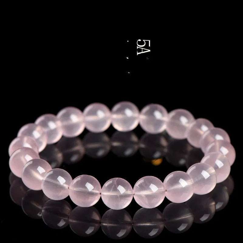 Natural pink starlight crystal round bead bracelet with polished finish in various sizes from 6mm to 22mm