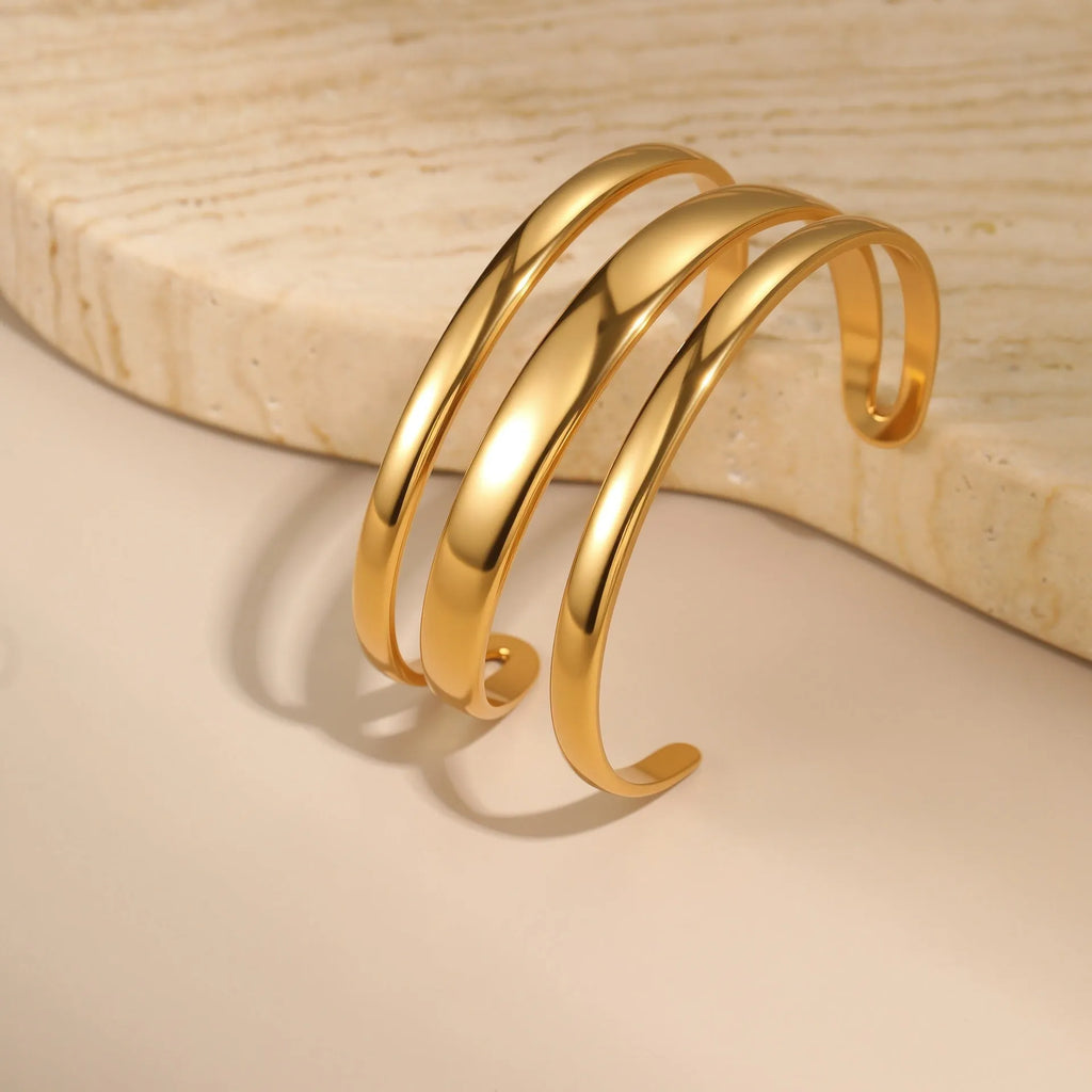 Stainless steel geometric line bracelet with simple opening clasp in gold or steel finish