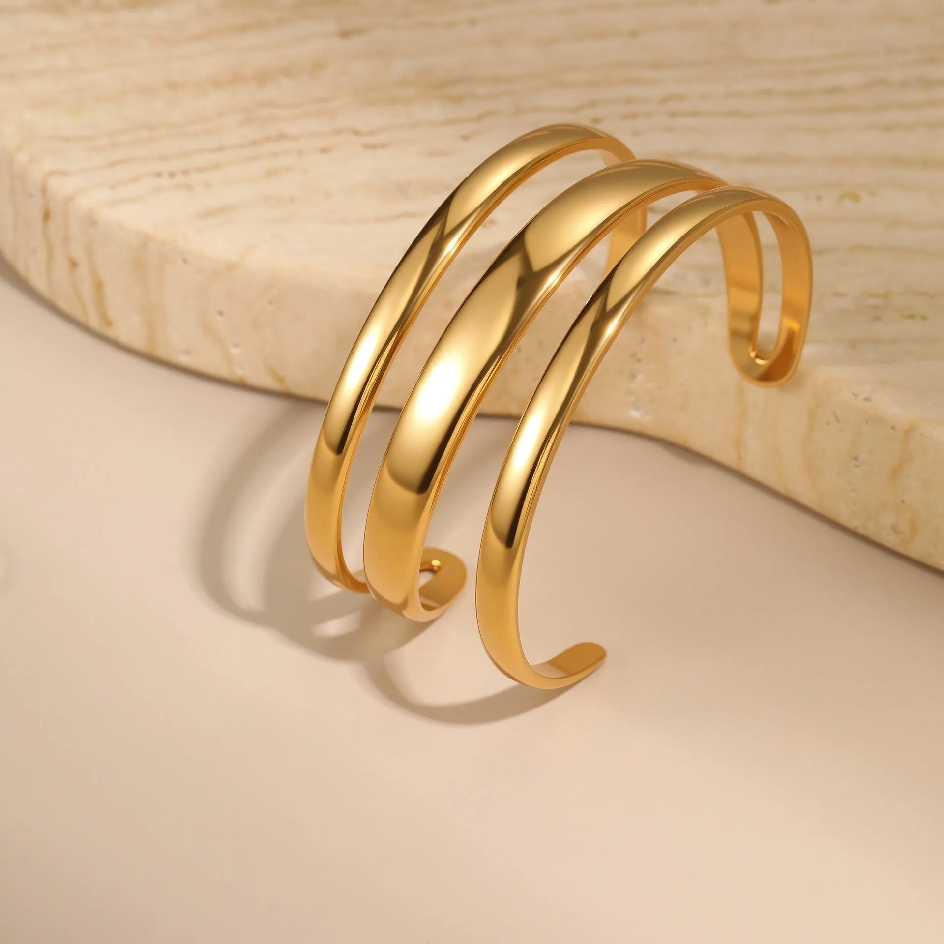 Stainless steel geometric line bracelet with simple opening clasp in gold or steel finish