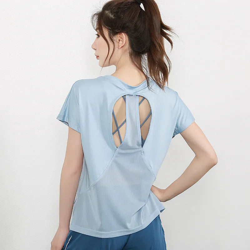 Women's short sleeve polyester sports t-shirt in pink, shown flat.
