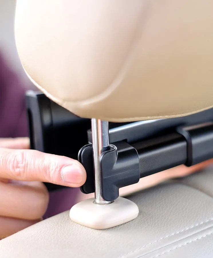 Black universal car phone holder mounted on vehicle rear seat base with tablet secured in snap-in mechanism