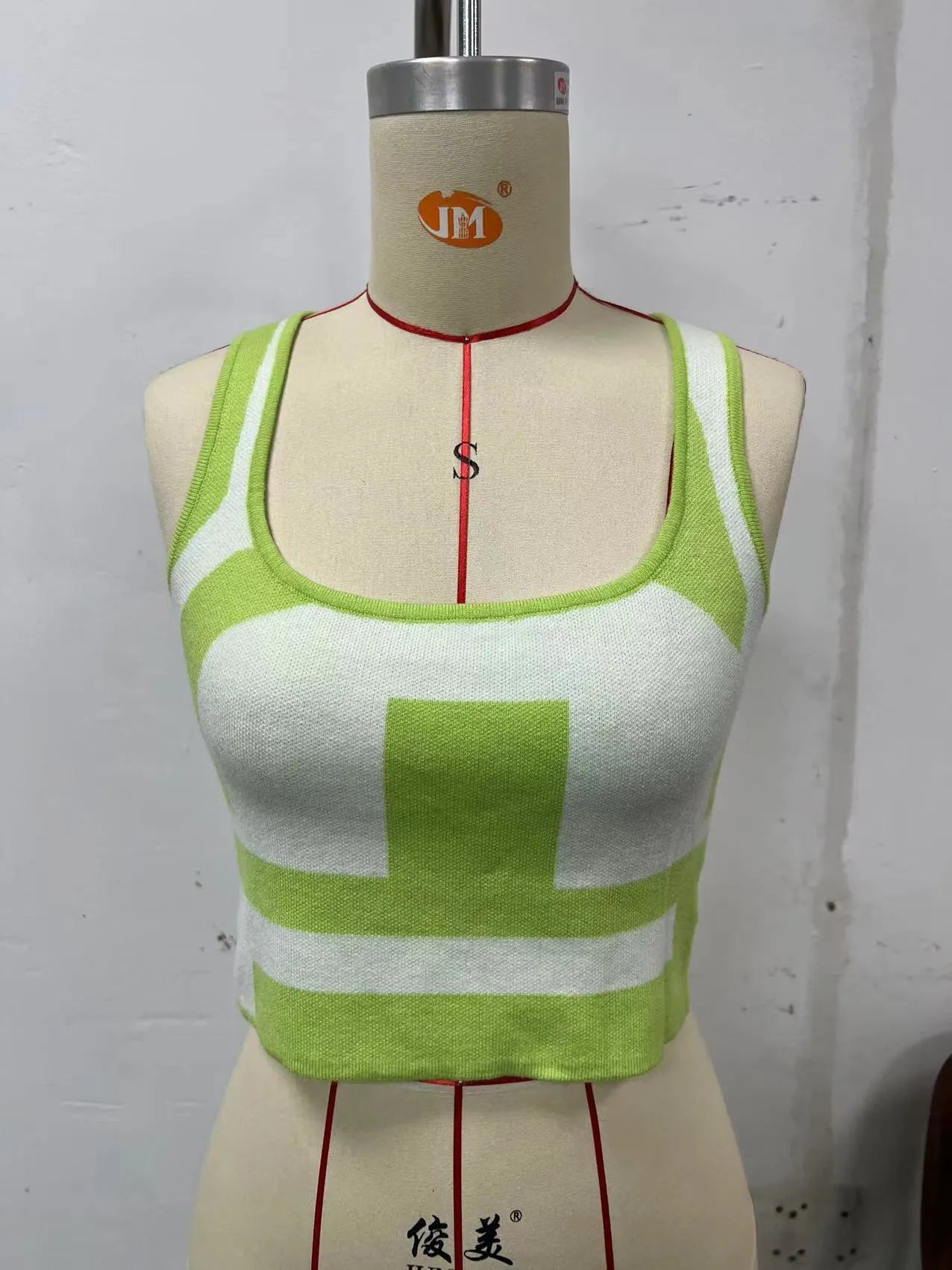 Women's slim fit U collar camisole vest in core-spun polyester, shown in a grass green colour.