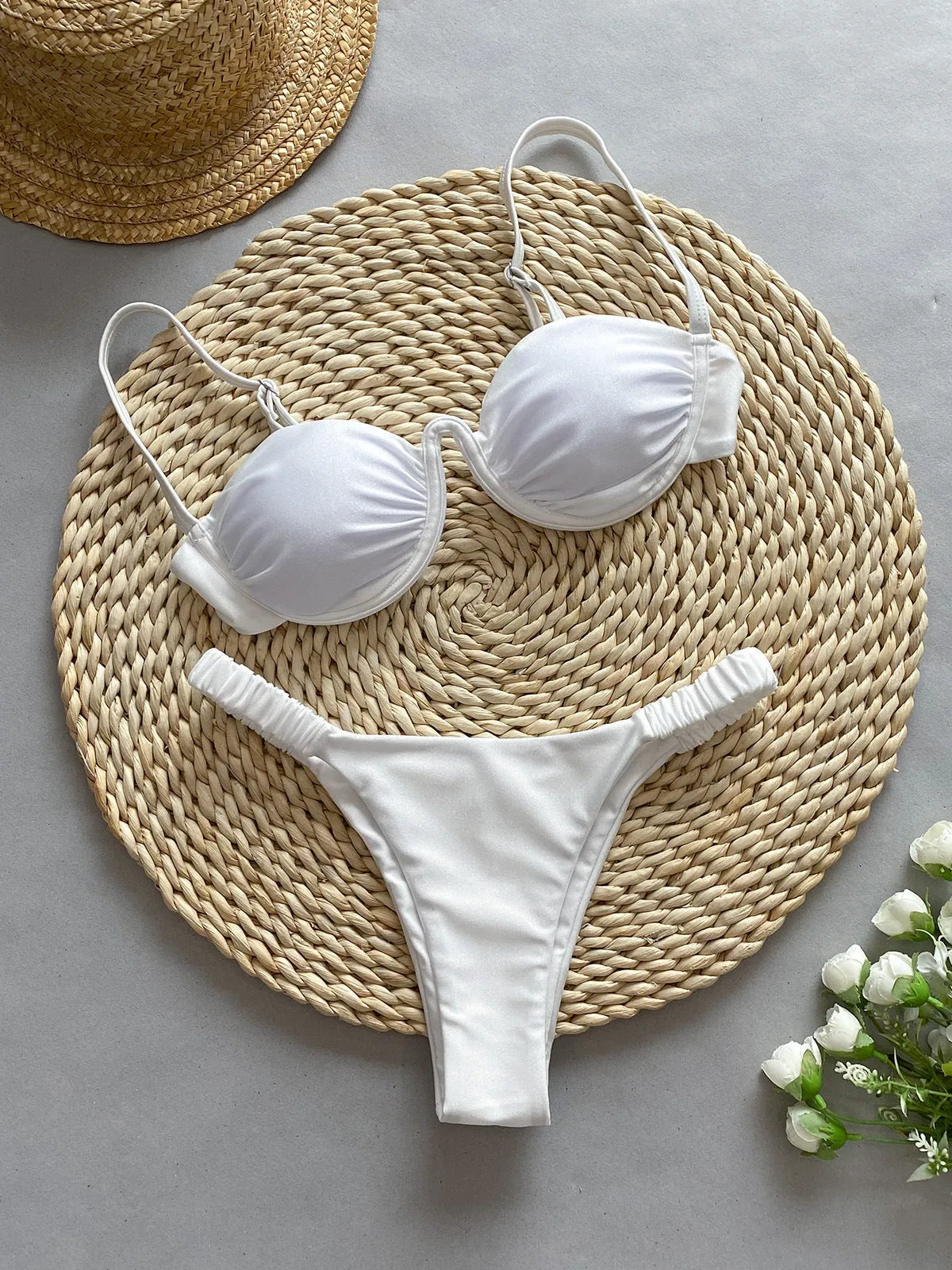 Women's black underwire bikini swimsuit set with split briefs on a neutral background.