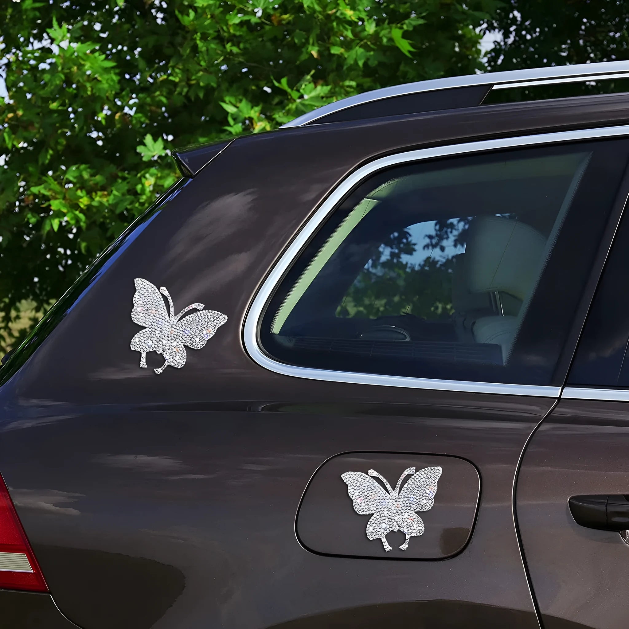 Close-up of a diamond-encrusted butterfly and bear claw design on a 7x6cm glass car sticker