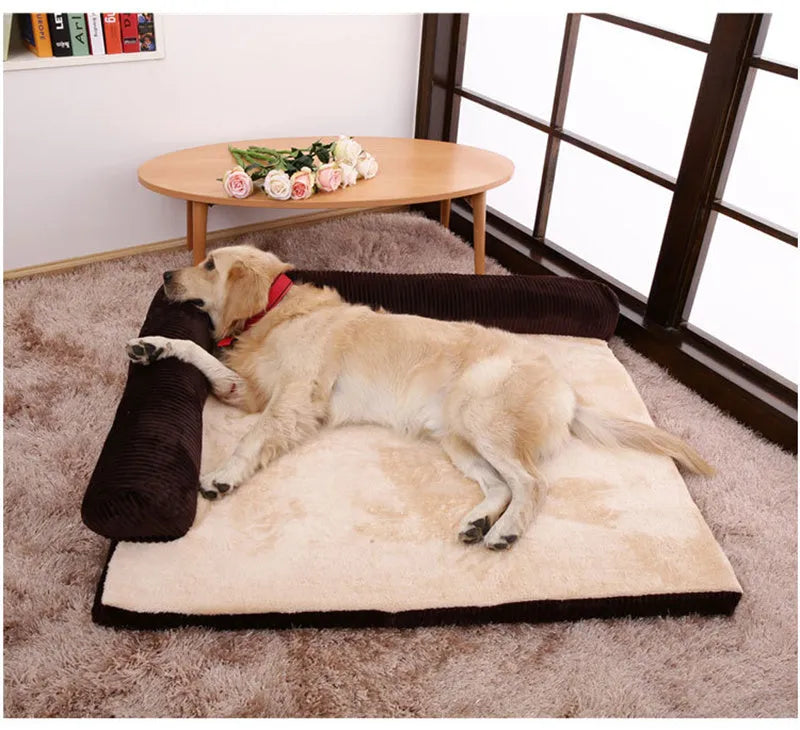 Corduroy dog sofa bed in grey, showing high sides and non-slip base, placed on a wooden floor.