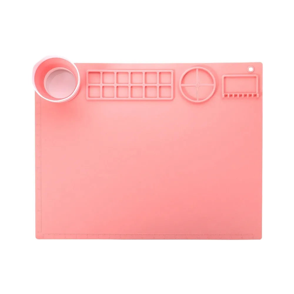 Green silicone painting mat measuring 50 by 40 centimetres with two round bowl wells for holding water or paint.