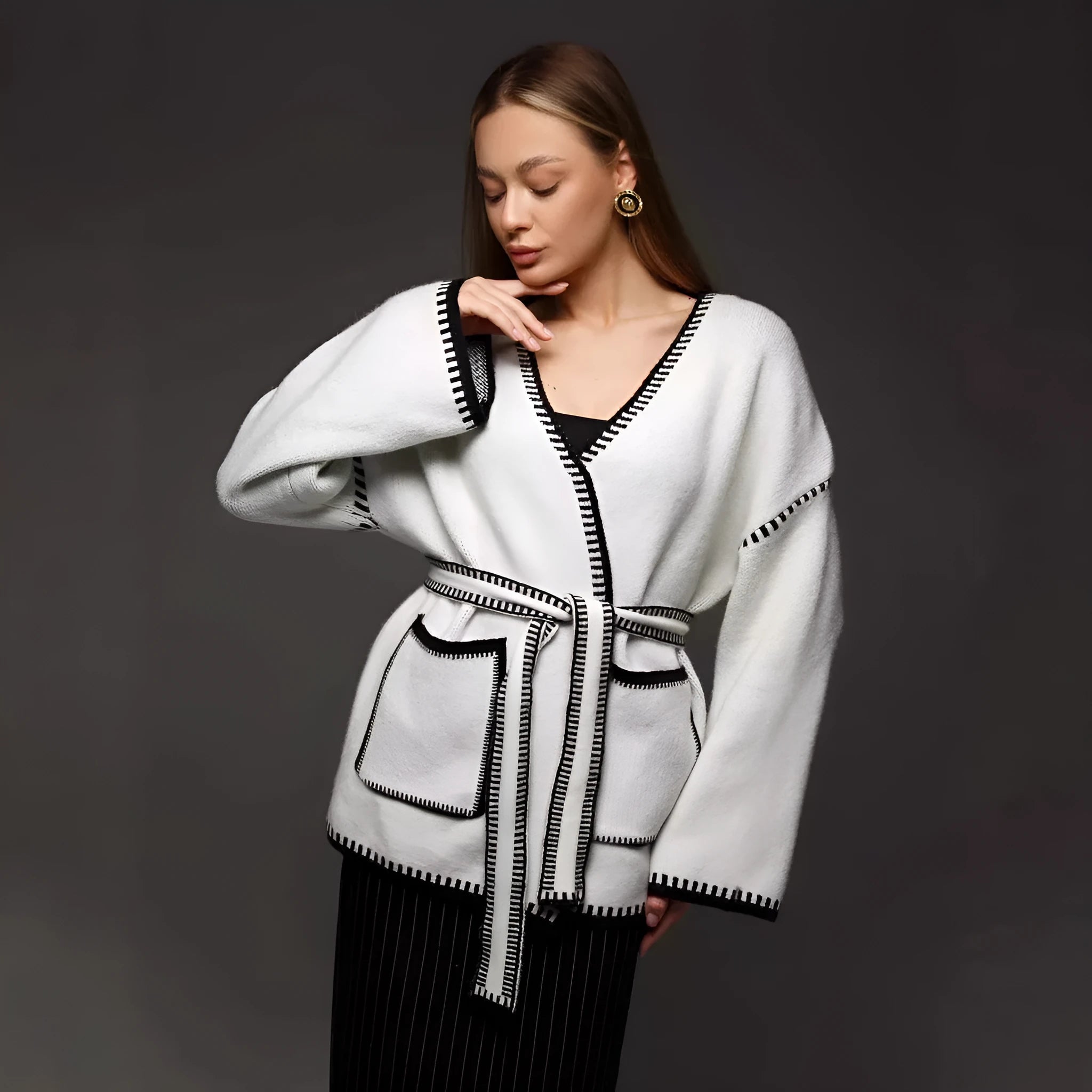 Lace-up front knitted cardigan in camel colour showing loose mid-length design and long sleeves