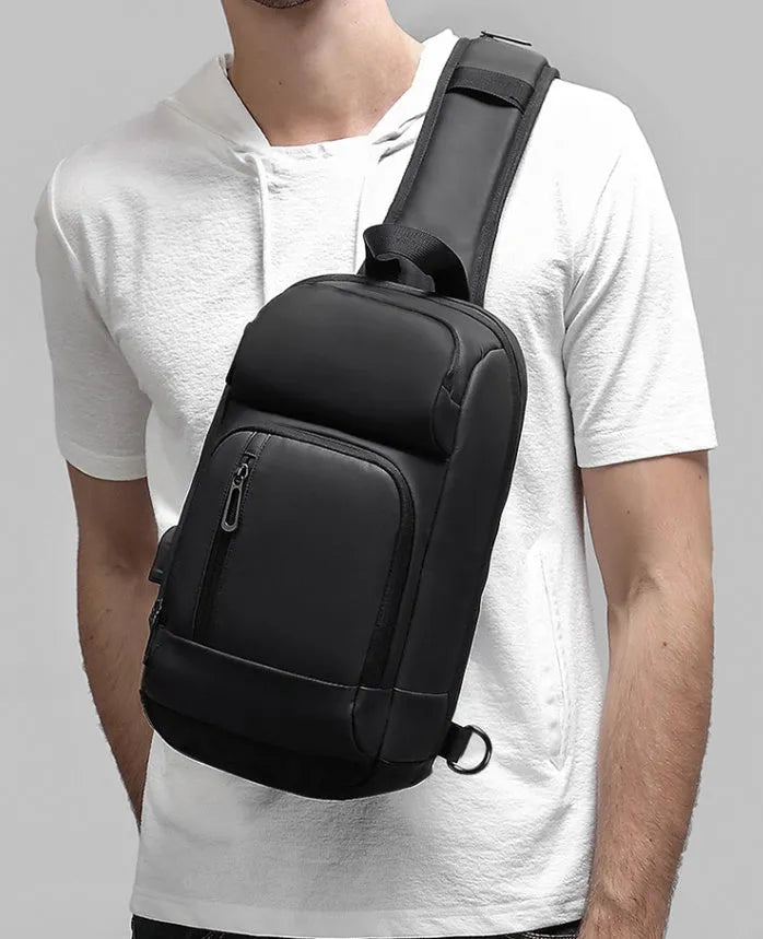 Black PVC outdoor shoulder bag showing internal organisation compartments and air cushion strap