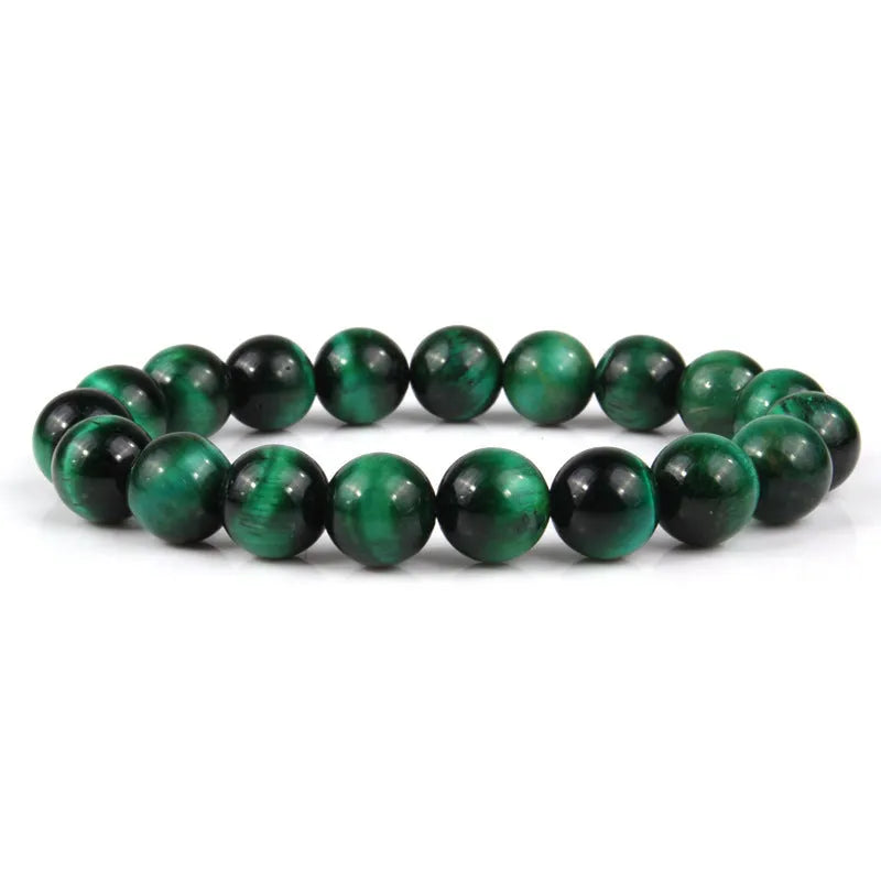 Tiger eye crystal stone bracelet showing round beads available in multiple colours and sizes on a wrist.