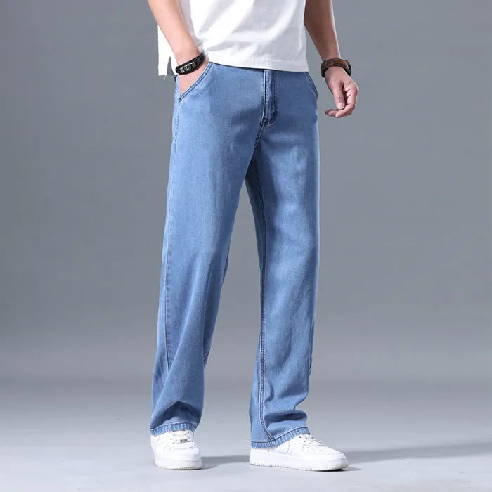 Men's loose fit straight-leg lyocell jeans in light blue colour with a zip fly.
