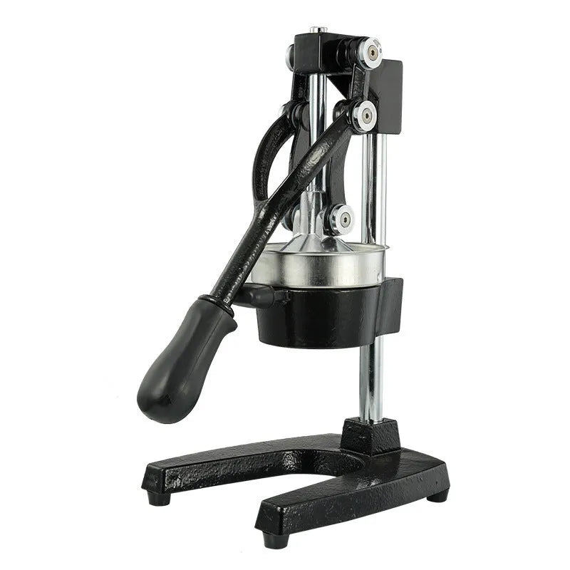 A black cast iron manual citrus juicer with a stainless steel strainer on a kitchen counter.