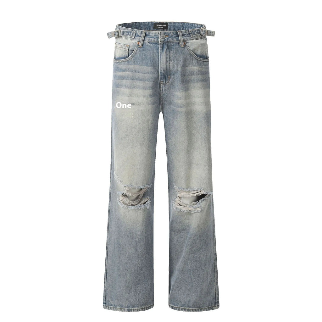 Man wearing blue straight-leg jeans with ripped detailing and an adjustable waistband.