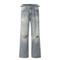 Man wearing blue straight-leg jeans with ripped detailing and an adjustable waistband.