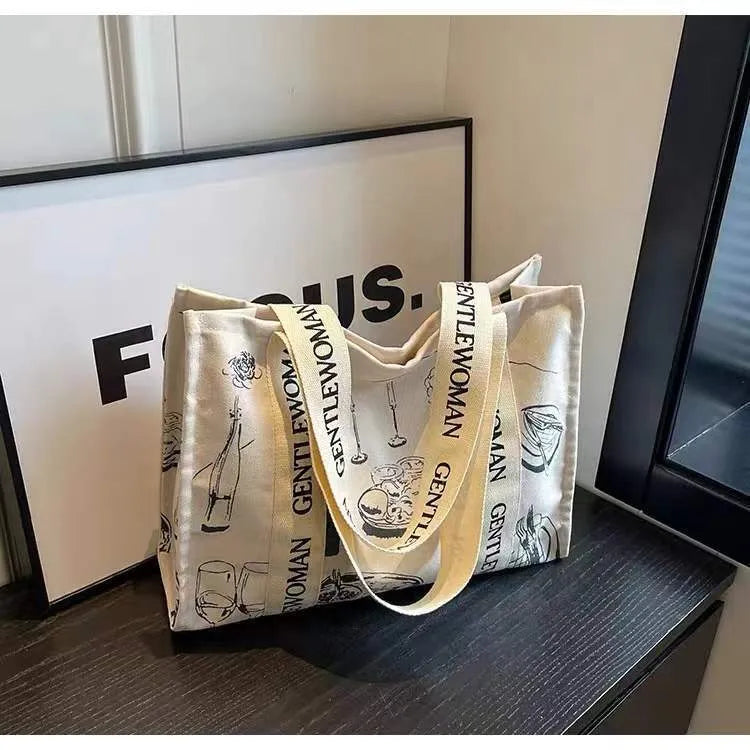 Women's large canvas tote bag with printed design options for travel and shopping.