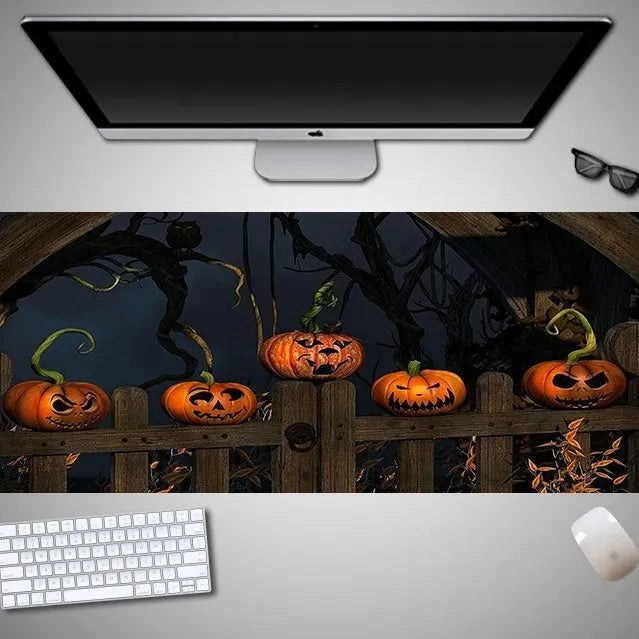 Large Halloween-themed computer mouse pad with graphic design on a desk