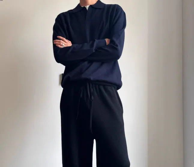 Men's loose-fit lapel-collar wool sweater in navy blue, laid flat showing front design.