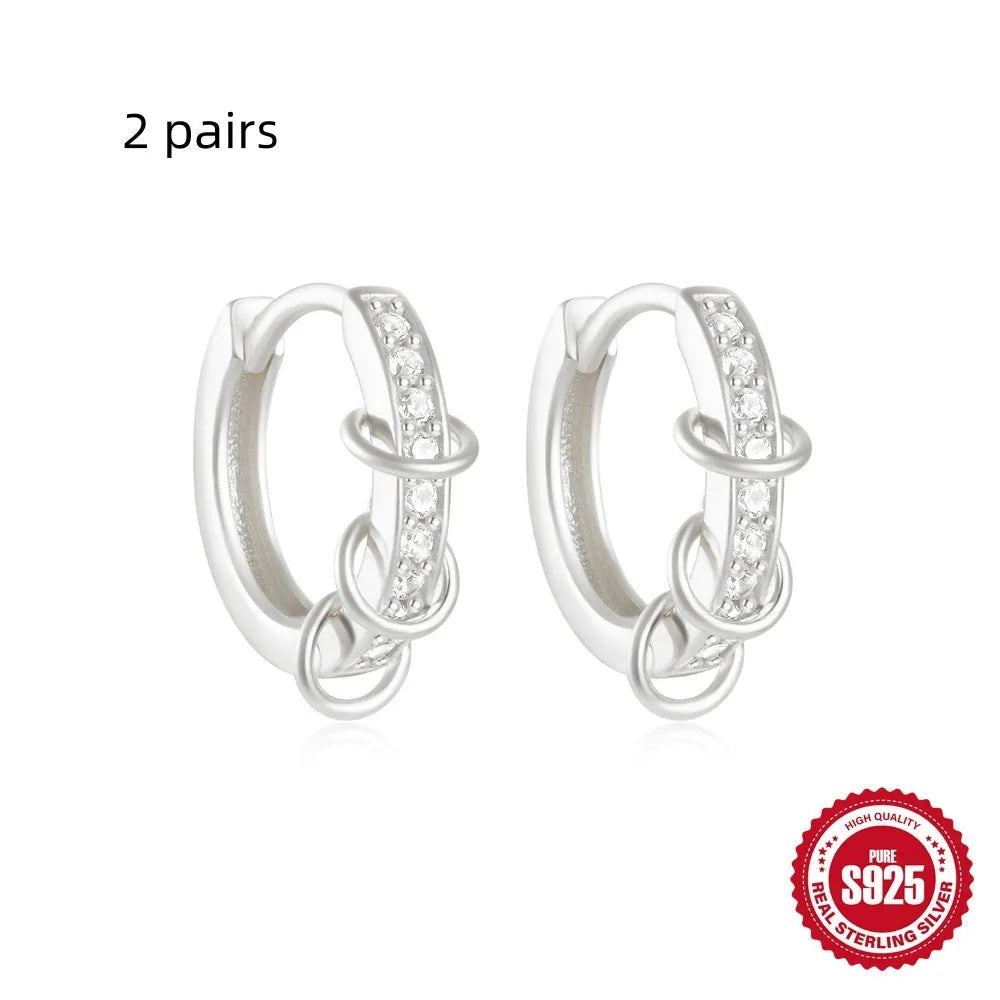 Sterling silver geometric stud earrings with small round design elements in gold or silver finish