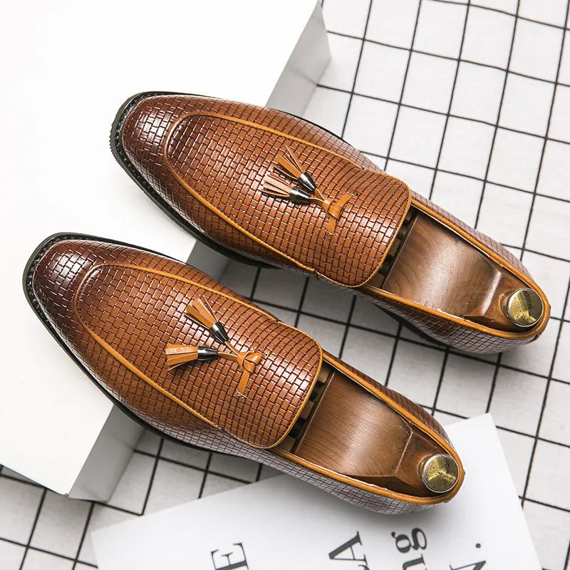 Men's black pointed slip-on business shoes with tassel detail on artificial PU leather upper